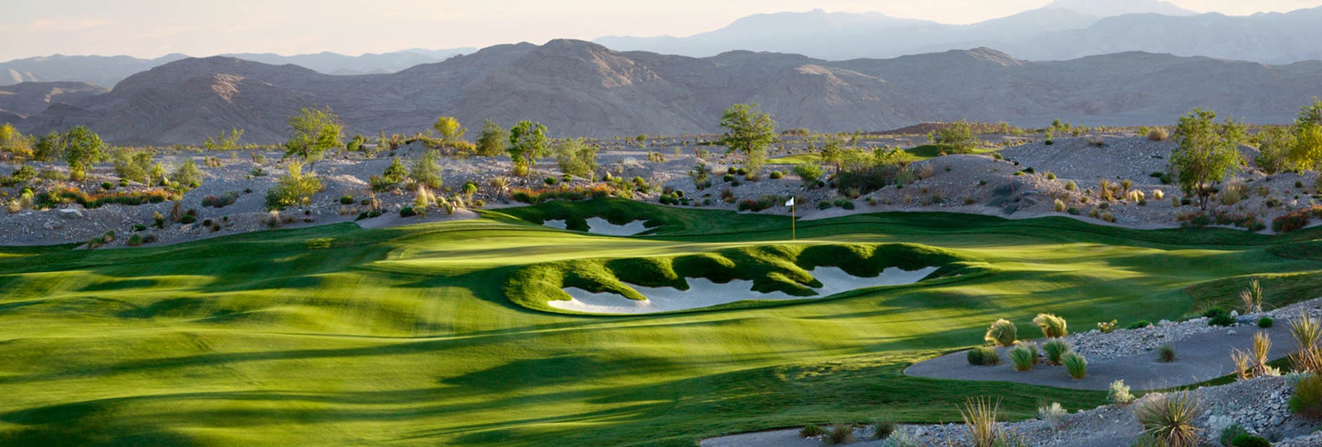 View of golf course fairway with mountains in distance