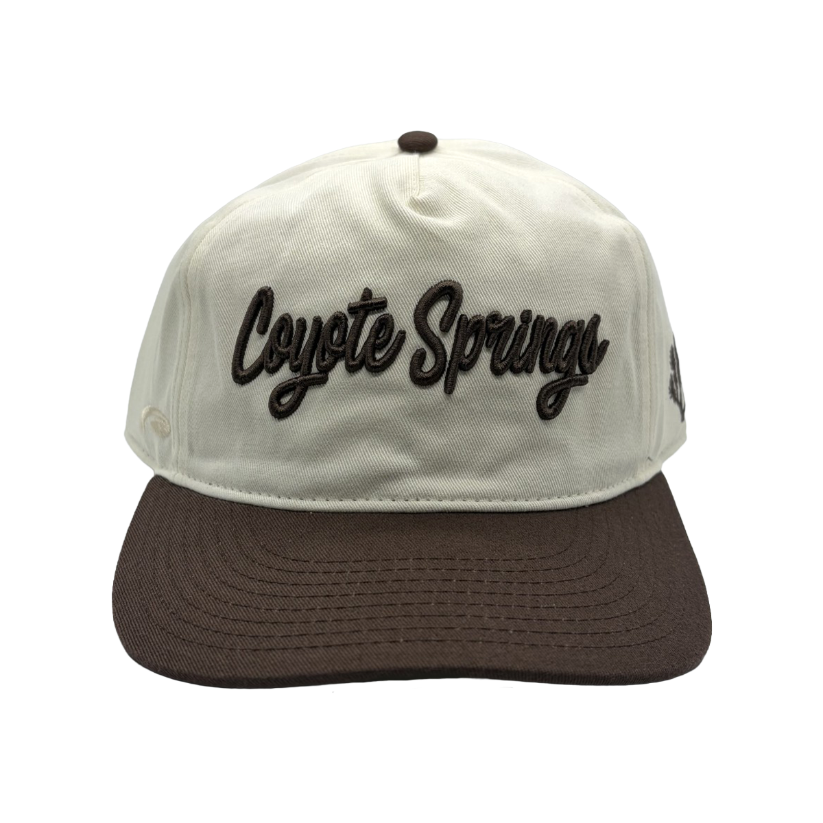 Classic style meets course-ready comfort. This cream and brown Coyote Springs cap features premium raised embroidery and a timeless two-tone design perfect for the golf course or everyday wear.