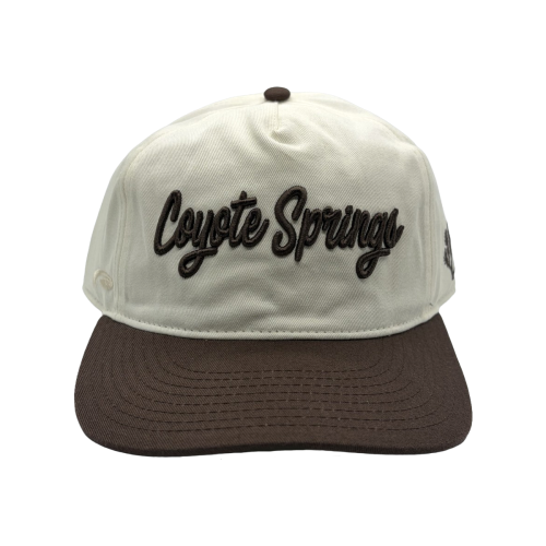Classic style meets course-ready comfort. This cream and brown Coyote Springs cap features premium raised embroidery and a timeless two-tone design perfect for the golf course or everyday wear.