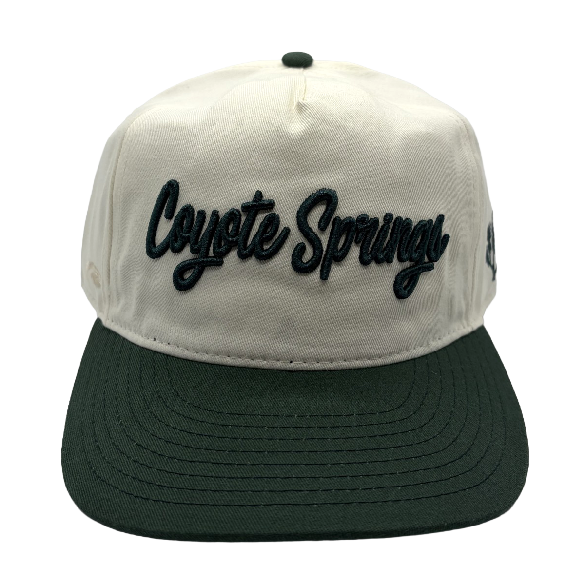 Classic style meets course-ready comfort. This cream and green Coyote Springs cap features premium raised embroidery and a timeless two-tone design perfect for the golf course or everyday wear.