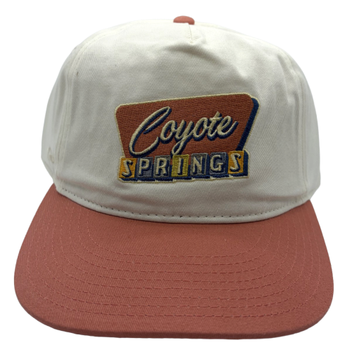 A vintage-inspired favorite, this cream and desert rose Coyote Springs cap features a retro embroidered logo and classic two-tone styling that's perfect for the course, clubhouse, or daily wear.