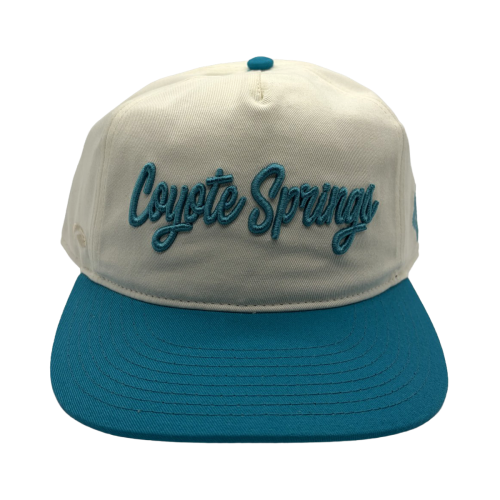 Classic style meets course-ready comfort. This cream and teal Coyote Springs cap features premium raised embroidery and a timeless two-tone design perfect for the golf course or everyday wear.